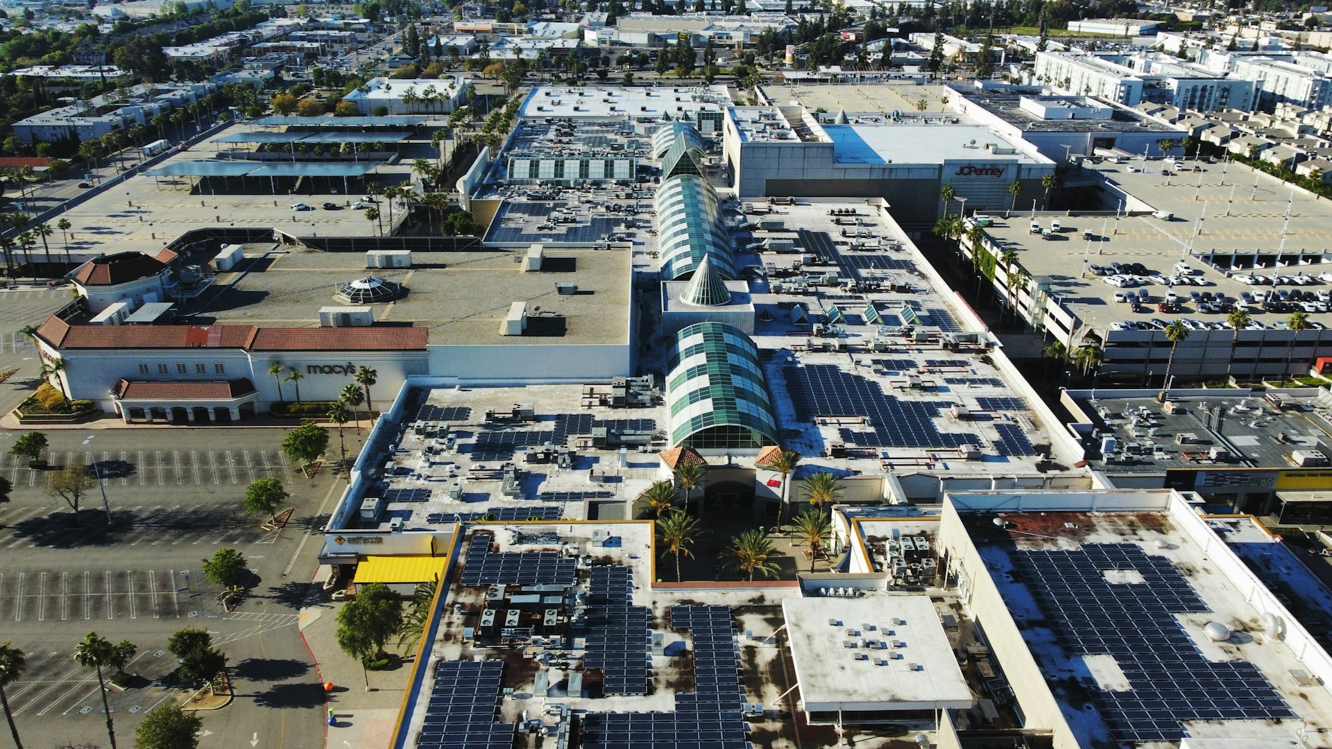 an aerial view of a parking lot with a lot of solar panels